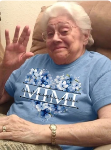 Happy customer wearing floral Mimi tee